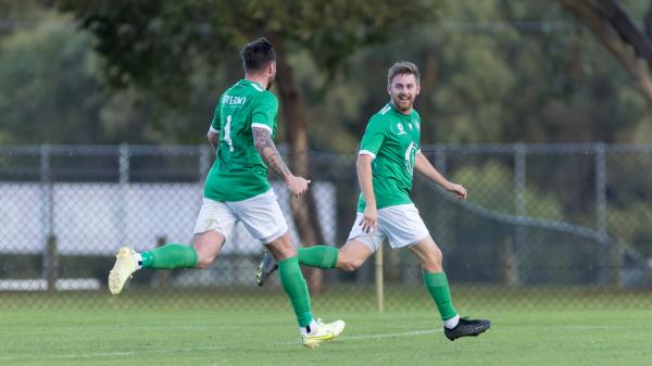 Ollie Annis, right, celebrates his winner for Olympic Kingsway against Perth Glory