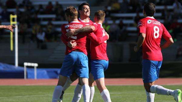 Bonnyrigg White Eagles players celebrate scoring against Cooma Tigers.