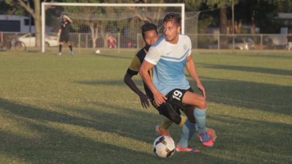 Palm Beach's Daniel Dragicevic shakes a Harimau Muda defender in his side's 4-3 win